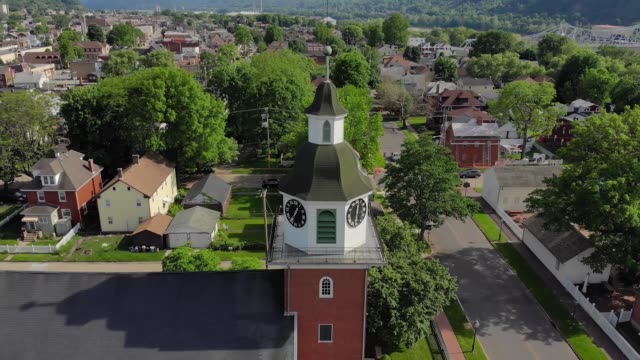 Slow-Reverse-Aerial-View-of-Small-Town's-Church-Steeple