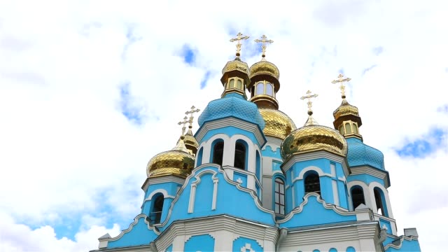 Orthodox-temple,-Clouds-above-the-temple,-golden-domes,-Timelapse,-exterior,-a-view-from-below,-Blue-temple,-blue-church,-Against-the-sky,-Golden-domes