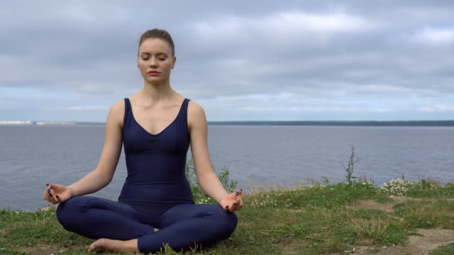 Female-in-classical-yoga-pose,-energy-concentration