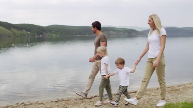 Family-of-Four-Walking-by-the-Lake