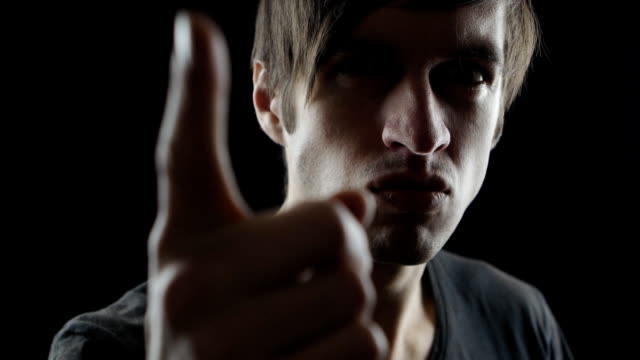 No,-Disallowing-Angry-Young-Man-Waving-Finger,-Black-Background