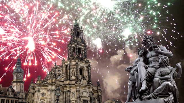 Sculpture-on-the-Bruhl-Terrace-and--Hofkirche-or-Cathedral-of-Holy-Trinity-and-holiday-fireworks---baroque-church-in-Dresden,-Sachsen,-Germany