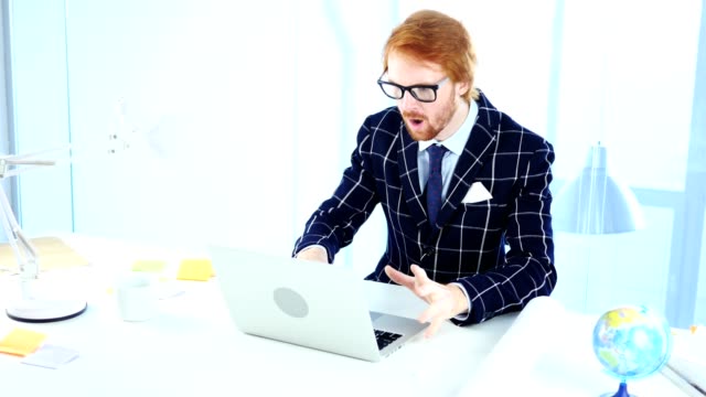 Redhead-Businessman-Upset-by-Loss-while-Working-on-Laptop,-Creative-Designer