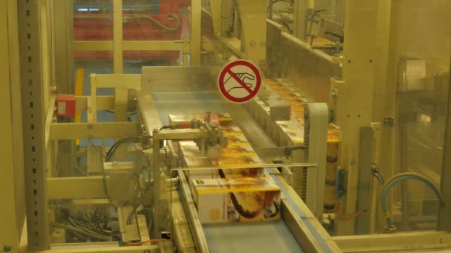 Folding-cardboard-boxes-on-a-conveyor-belt-in-a-rice-factory-–-4K