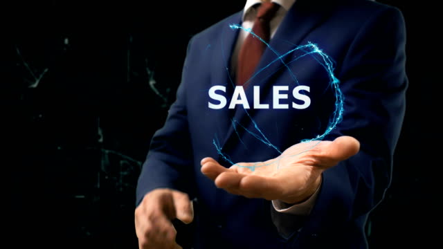 Businessman-shows-concept-hologram-Sales-on-his-hand
