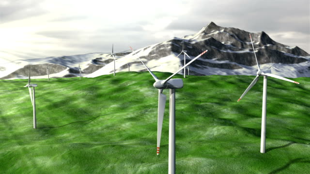 Wind-generators-farm-on-field-against-a-mountains