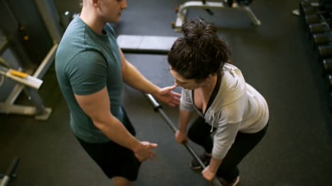Woman-Training-in-Gym-with-Male-Instructor