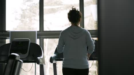 Sportswoman-Exercising-and-Looking-Out-of-Window