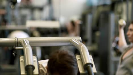 Man-and-Woman-Working-Out-in-Gym
