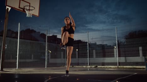 Beautiful-Energetic-Fitness-Girl-Doing-Exercises.-She-is-Doing-a-Workout-in-a-Fenced-Outdoor-Basketball-Court.-Evening-Footage-After-Rain-in-a-Residential-Neighborhood-Area.