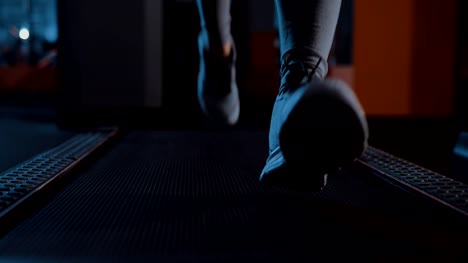 Running-in-sneakers-on-a-treadmill.-Legs-close-up