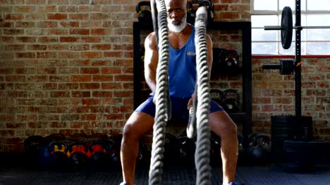 Senior-man-doing-gym-rope-training-in-the-fitness-studio-4k