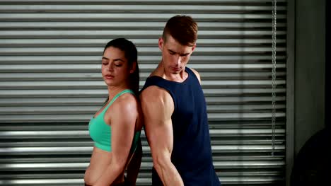 Fit-couple-exercising-with-dumbbells