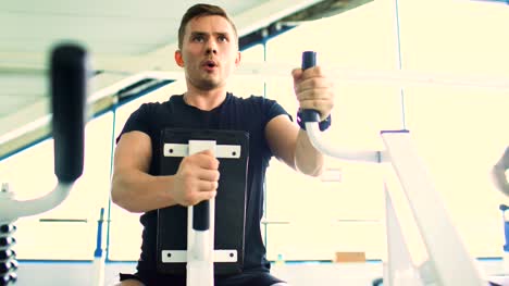 Handsome-sporty-man-is-exercising-in-fitness-club-and-gym-center