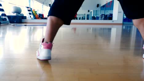 Close-up---the-man-in-sneakers-dancing-in-the-gym