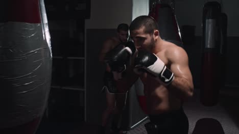 Two-Combat-Athletes-Training-with-Punch-Bags