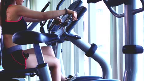 Young-Woman-Exercising-on-the-Cross-Trainer-Machine