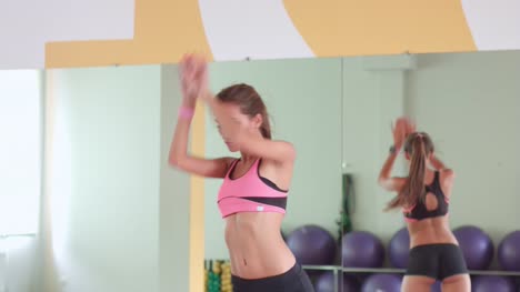 Woman-perform-leanings-forward-at-aerobics-hall