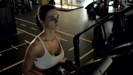 Attractive-fitness-woman-walking-on-treadmill-for-cardio-training-in-gym-club
