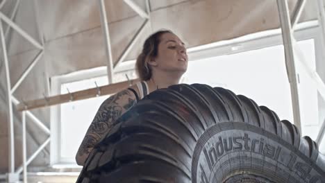 Sportlerin-spiegeln-schweren-Reifen