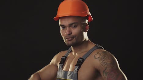 Handsome-muscular-constructionist-smiling-wearing-hardhat