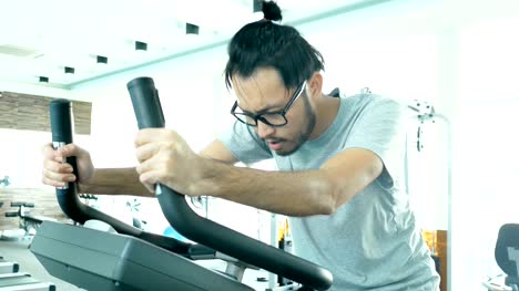 Asian-man-exercise-in-sport-gym.-People-with-sport-concept.