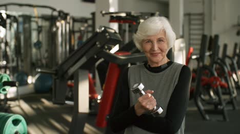 Senior-Woman-with-Dumbbell-in-Gym