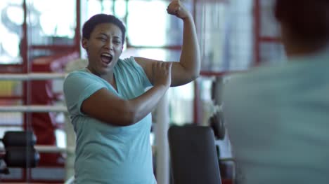 Black-Woman-Flexing-in-Gym-and-Laughing