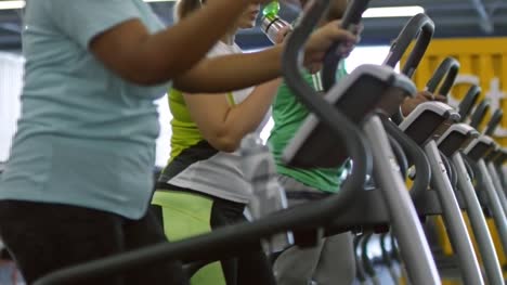 Cheerful-Women-Chatting-on-Stepper-Machines-in-Gym