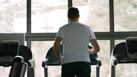 Man-Jogging-on-Treadmill-Alone-in-Gym