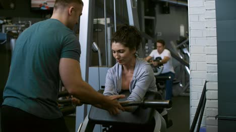 Woman-Training-with-Preacher-Curl-Bench