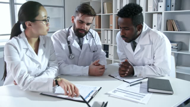 Young-Specialists-in-Lab-Coats-at-Meeting