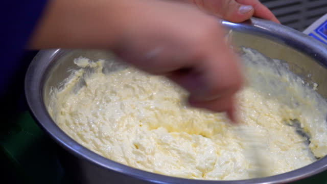 A-man's-hand-stirring-white-sauce.-The-chef-prepares-the-sauce-and-cheese.-Food.-Kitchen.-healthy-diet.-Close-up.-HD