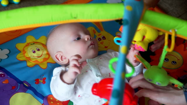Little-Baby-Playing-with-Toys-On-Mat