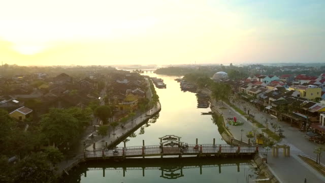 motion-above-river-past-bridge-in-Hoi-An-in-morning