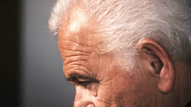Profile-of-sad-old-man-raising-his-head