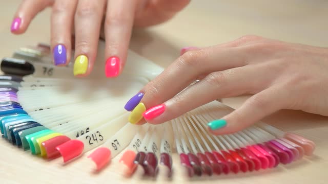 Hands-choosing-nail-color,-slow-motion.