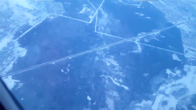 Airplane-flying-over-snowy-suburb-in-the-early-morning-FullHD