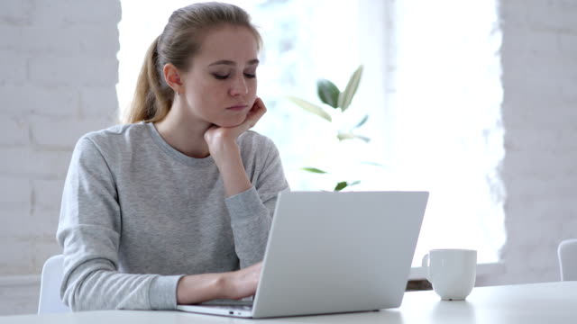 Sad-Young-Woman-Sitting-in-Office