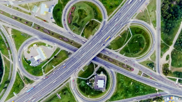 Static-vertical-top-down-aerial-view-of-traffic-on-freeway-interchange-at-night.-timelapse-background