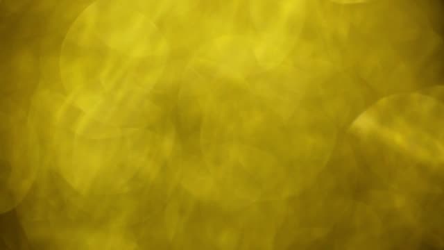 Yellow-colord-bokeh,-blurred-glass-particles.-Abstract-Motion-Background