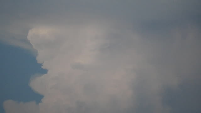 An-aircraft-passes-in-front-of-gigantic-cumulonimbus
