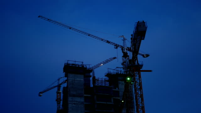 4K-footage.-crane-rotate-at-construction-site-in-the-dusk