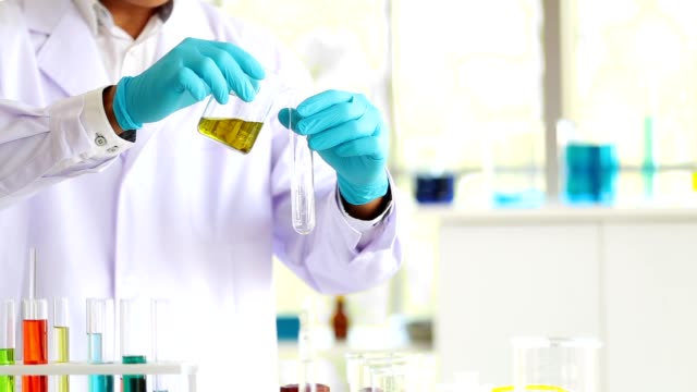 Closeup-man-laboratory-scientist-working-at-lab-with-test-tubes