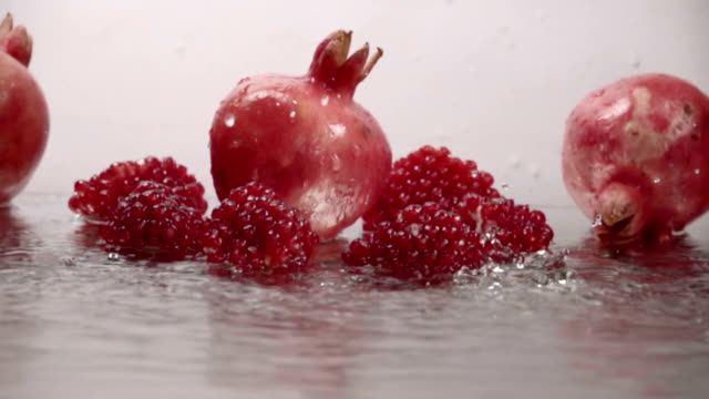 Falling-drops-of-water-on-pomegranate.-Slow-motion