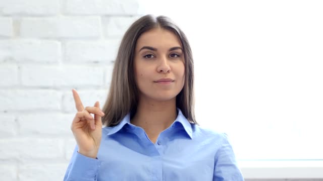 Portrait-of-Beautiful-Young-Woman-Waving-Finger-to-Refuse