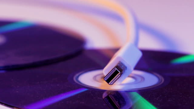 Closeup-of-white-Mini-Displayport-cable-with-it's-reflection-on-blank-disc