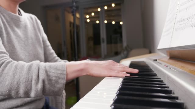 Hands-of-a-woman-playing-piano