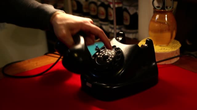Dialing-with-an-retro-rotary-phone,-man-in-the-office-dials-the-old-phone