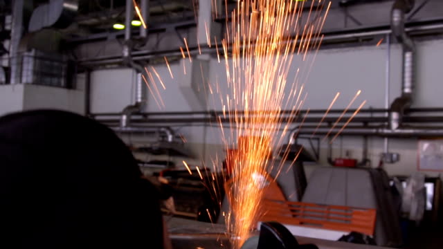 Man-works-circular-saw.-Flies-of-spark-from-hot-metal.